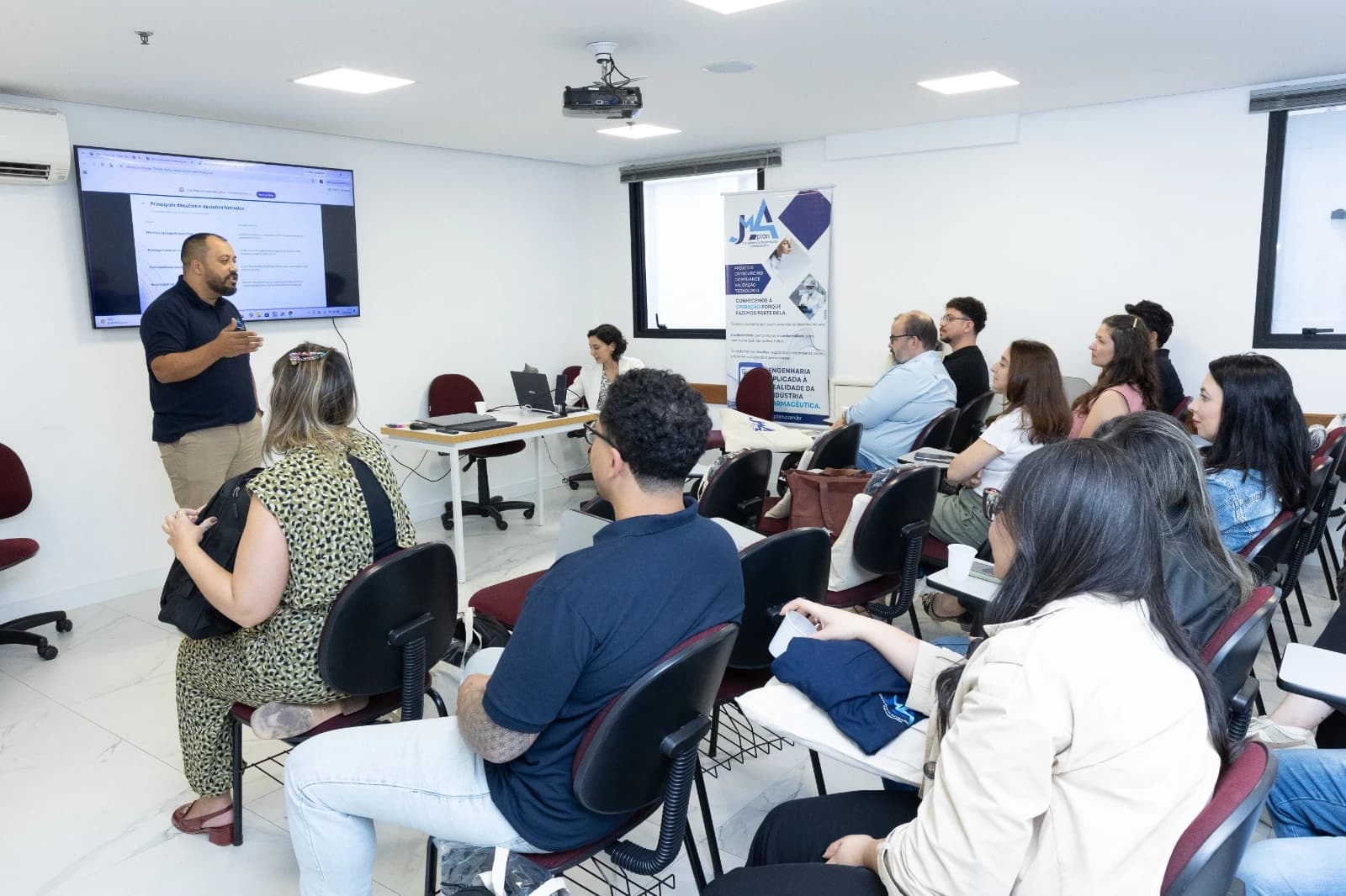 A JMA Plan professional presenting to a group